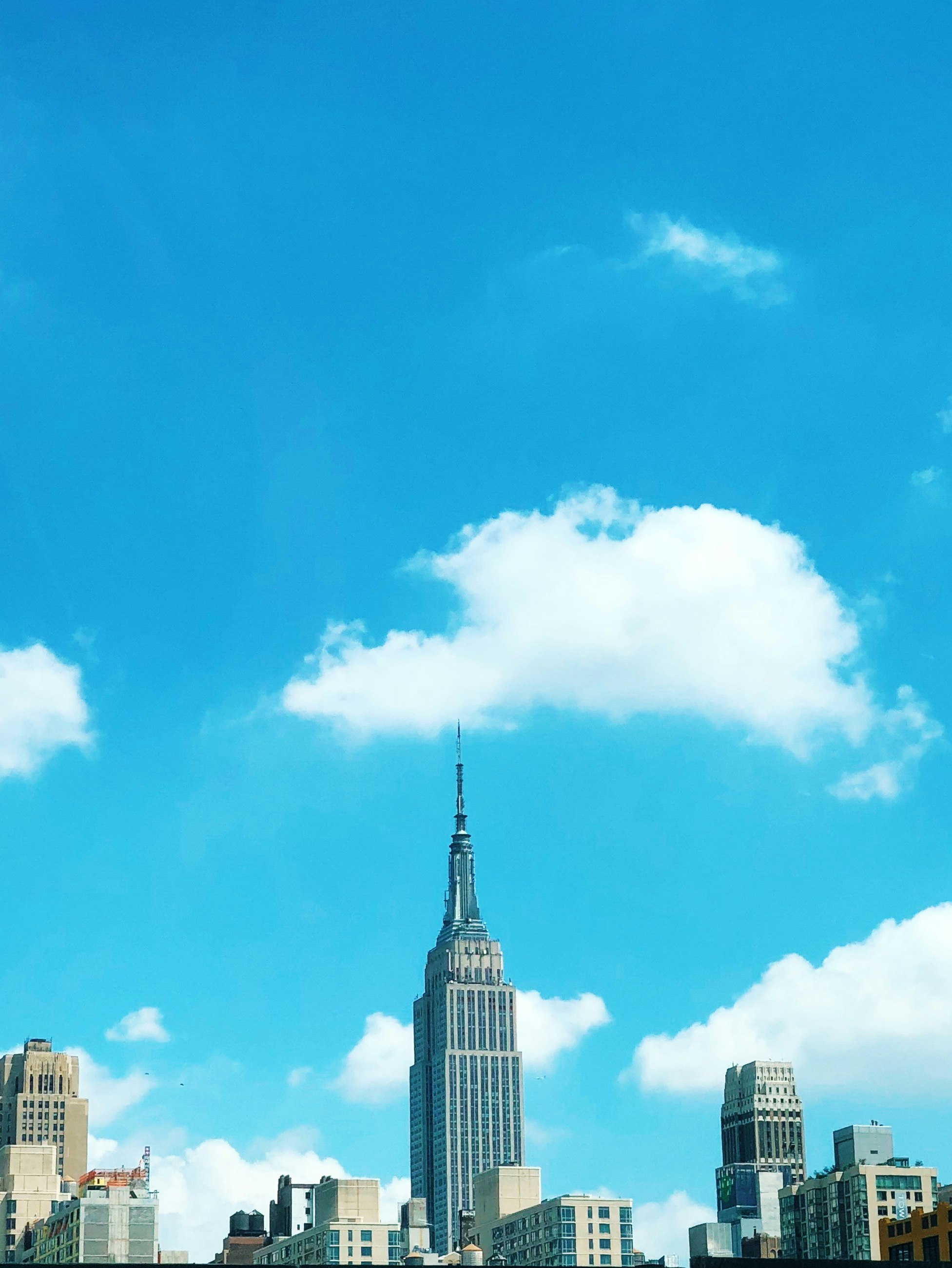 Empire State building surrounded by buildings